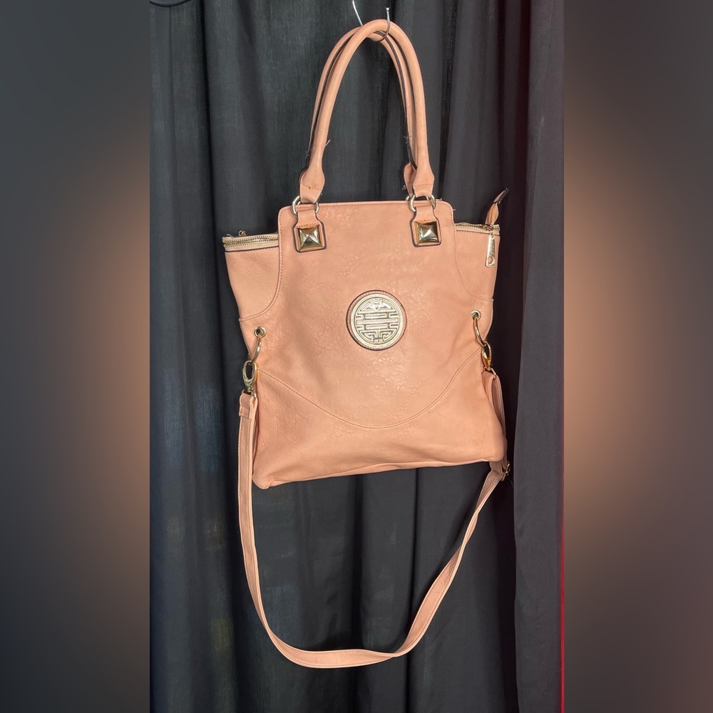 Brand new peach, colored leather like women’s purse with gold emblem